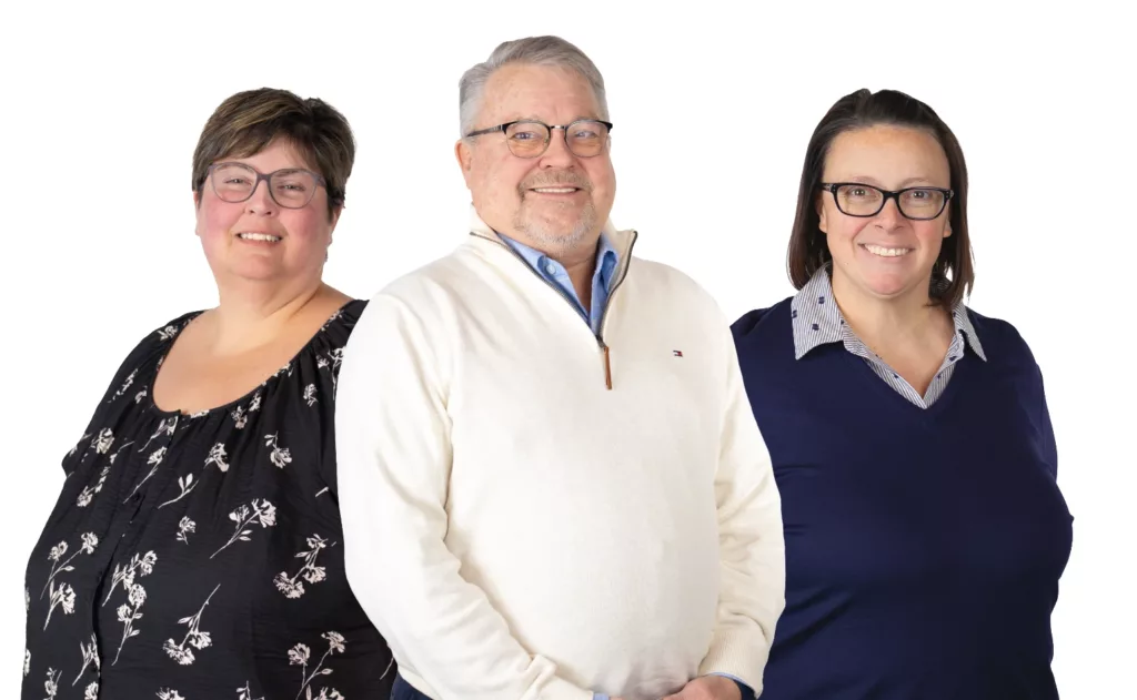 The Baker Insurance team in Bremen, Indiana, consisting of Robyn, Tommy, and Beth, posing with each other.